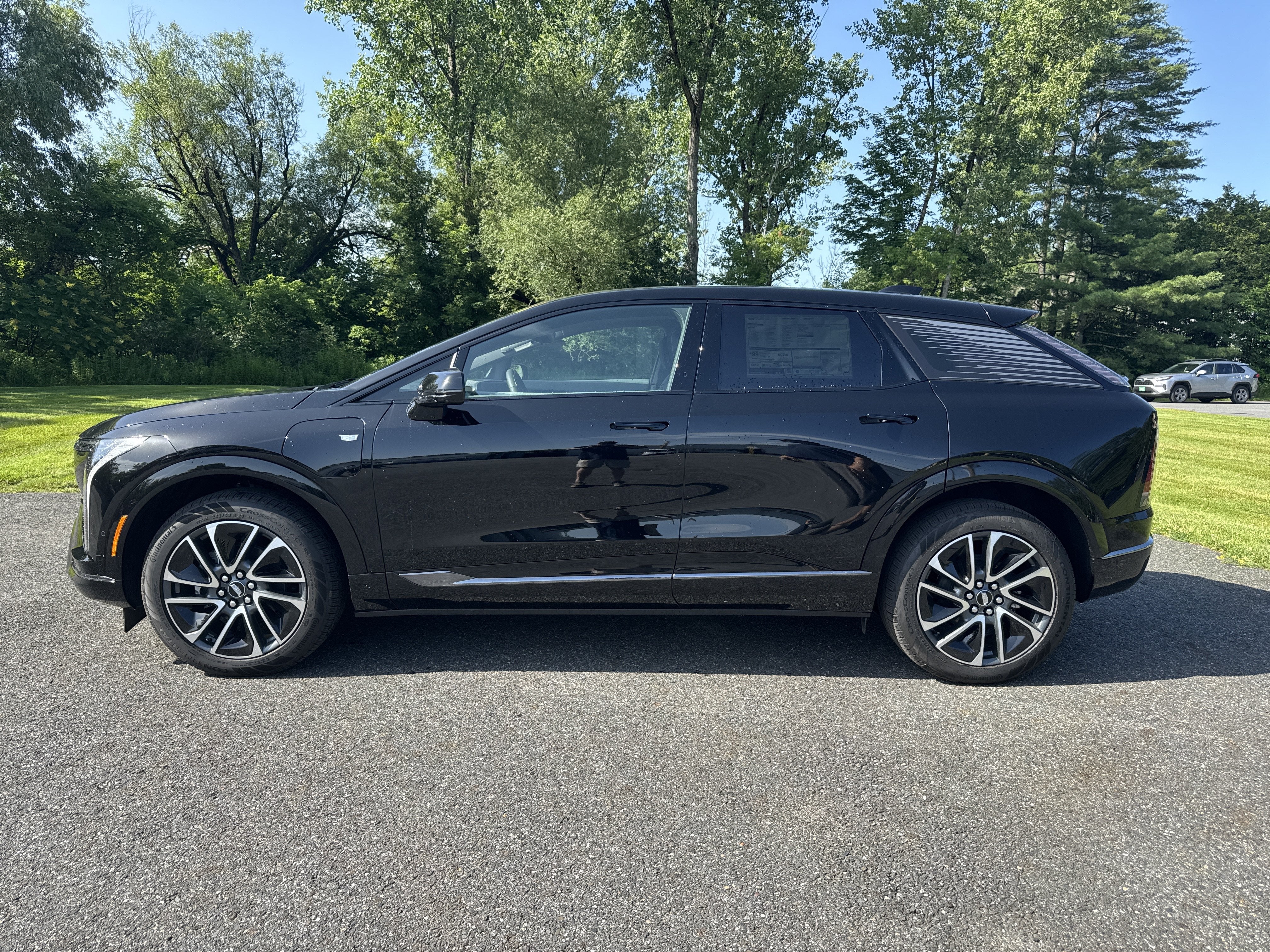 2026 Cadillac OPTIQ Sport in Black Raven — front three-quarter view